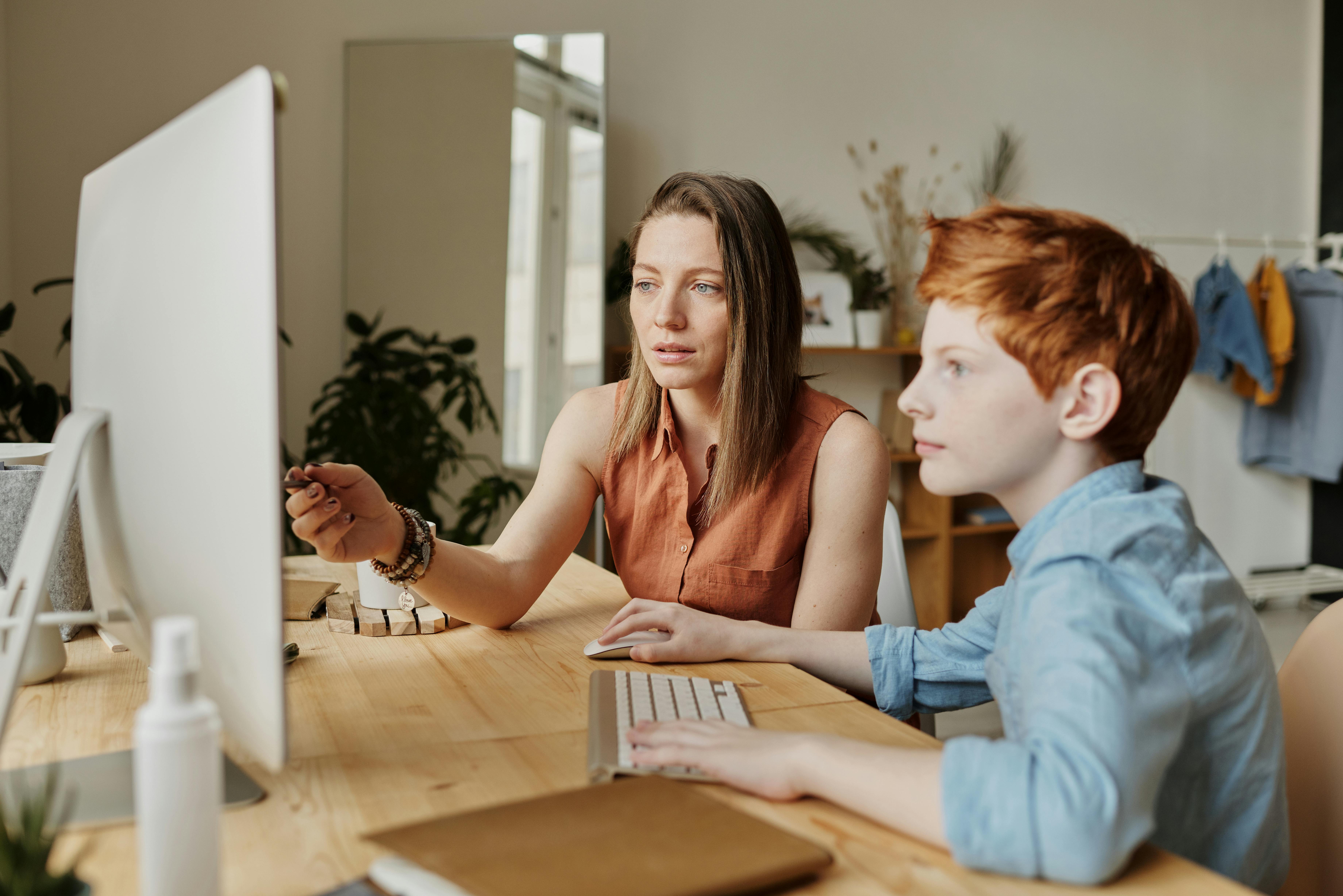 teen and monm behind computer
